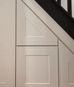 Close up of vinyl wrapped panelled door fronts following the rake of the staircase