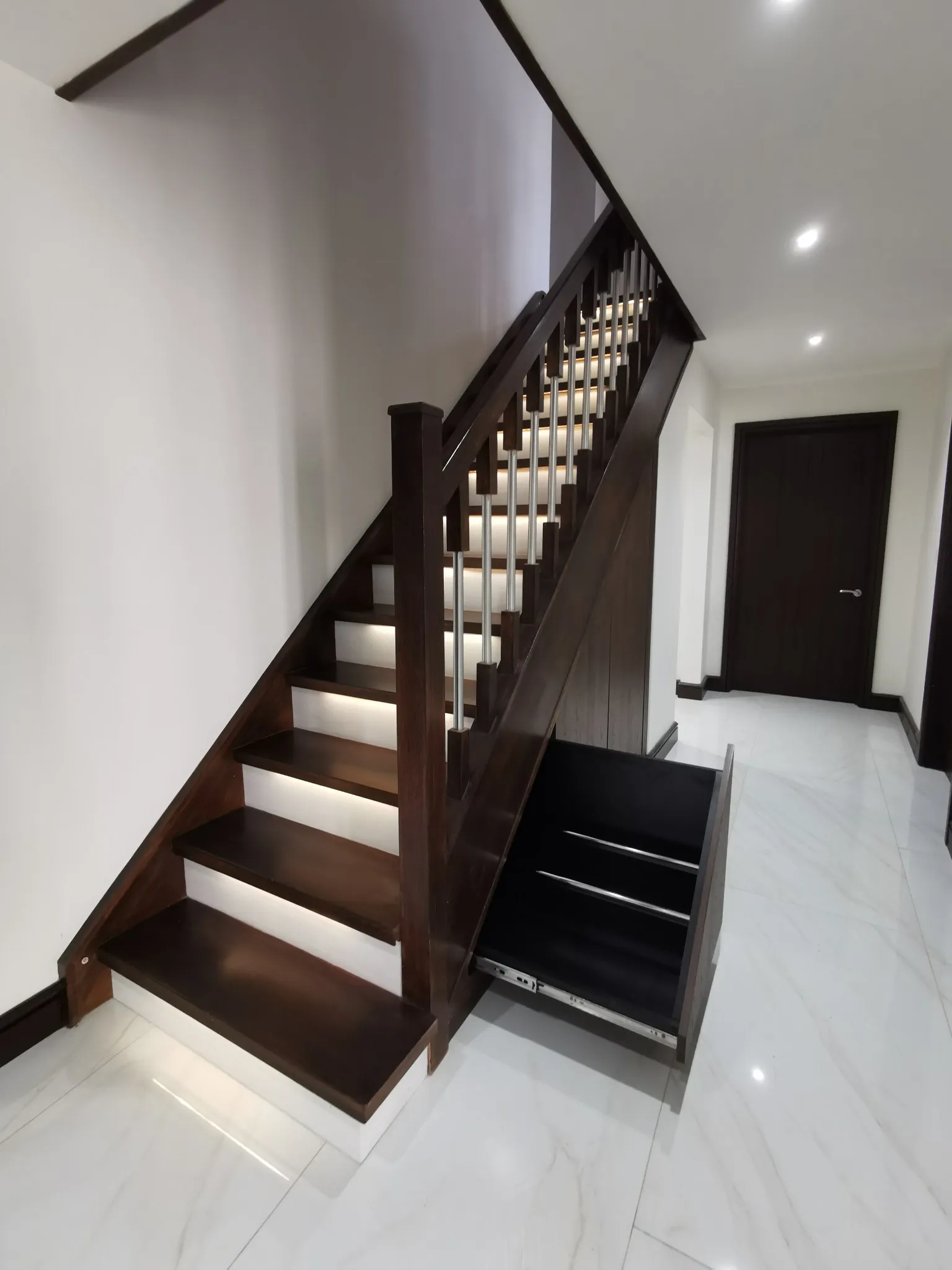 A deep walnut pull out drawer extended on full extension runners