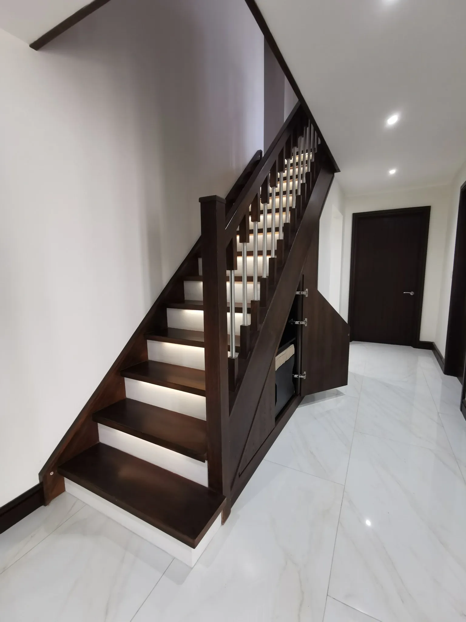 The middle walnut door open, with a storage box kept inside