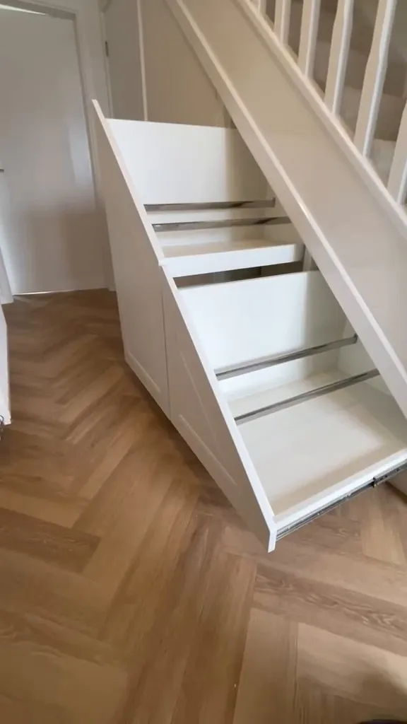Two angled under stairs drawers pushed open and fully extended