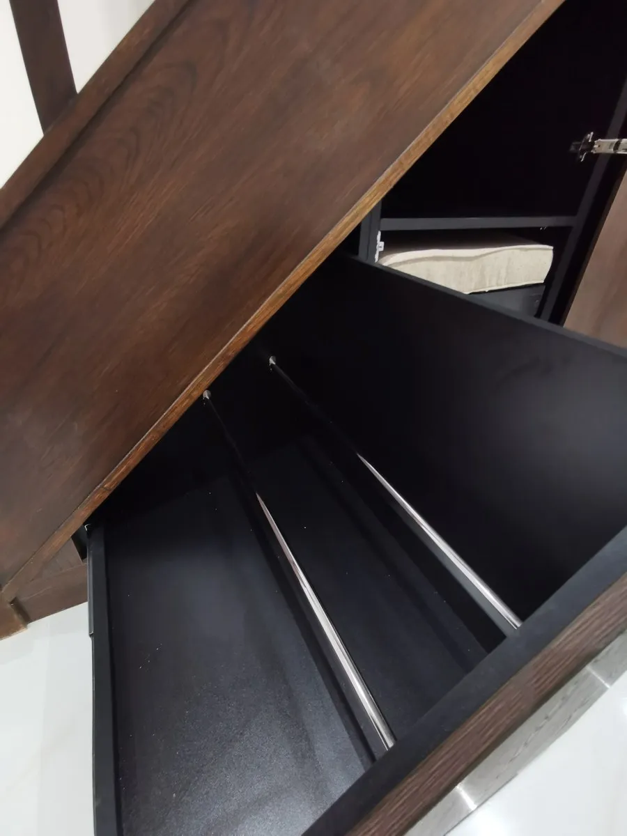 Chrome rails inside a deep walnut pull out drawer